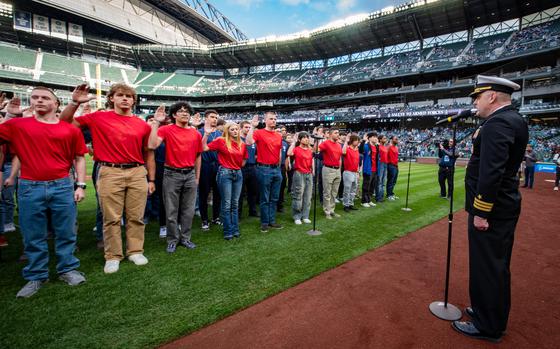 U.S. Navy Cmdr. Richard Jarchow, commanding officer of Navy Talent Acquisition Group Pacific Northwest, administers the oath of enlistment to future service members during a joint-service ceremony at T-Mobile Park. The event was part of the Seattle Mariners’ Salute to Armed Forces Night and included 71 recruits representing the Army, Navy, Marine Corps, Air Force and Coast Guard.  Navy Talent Acquisition Group Pacific Northwest manages 35 recruiting stations across five states, with a mission to recruit the next generation of warrior Sailors to strengthen Navy readiness and leadership. (U.S. Navy photo by Chief Mass Communication Specialist Torrey W. Lee)