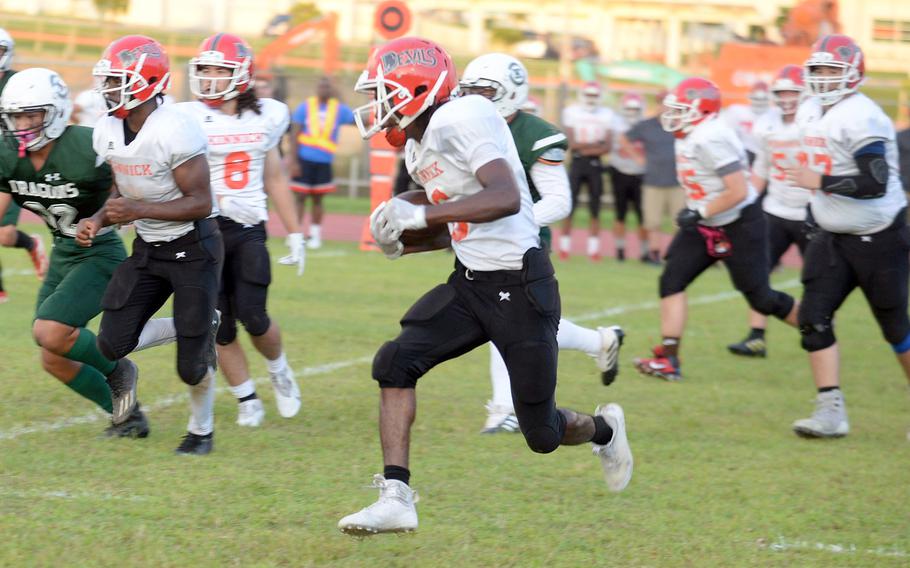 Nile C. Kinnick's Trey Bennett looks for running room to the left side.