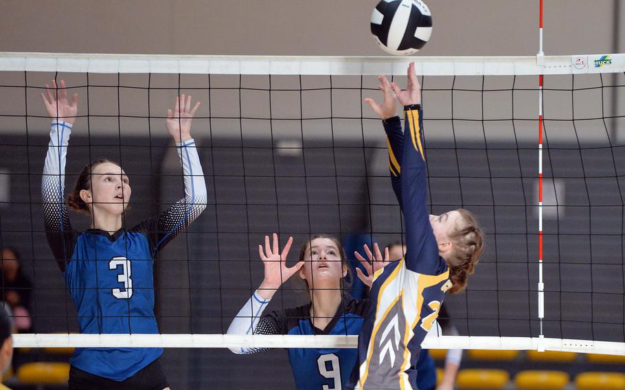 Ansbach’s Natalie Ritter sets the ball as Brussels’ Lucia Martinez and Patricia Rullan watch from across the net. Ansbach defeated Brussels 25-21, 17-25, 25-20, 25, 20, in the Division III final at the DODEA-Europe volleyball championships at Ramstein, Germany, Oct. 28, 2023.