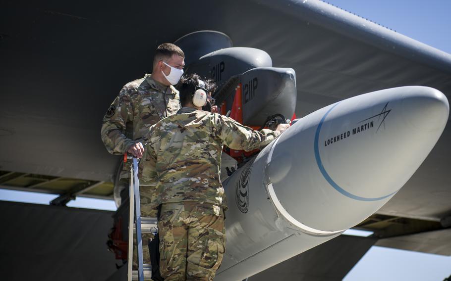 Master Sgt. John Malloy and Staff Sgt. Jacob Puente, both from 912th Aircraft Maintenance Squadron, secure the AGM-183A as it is loaded under the wing of a B-52H Stratofortress at Edwards Air Force Base, Calif., Aug. 6, 2020. 