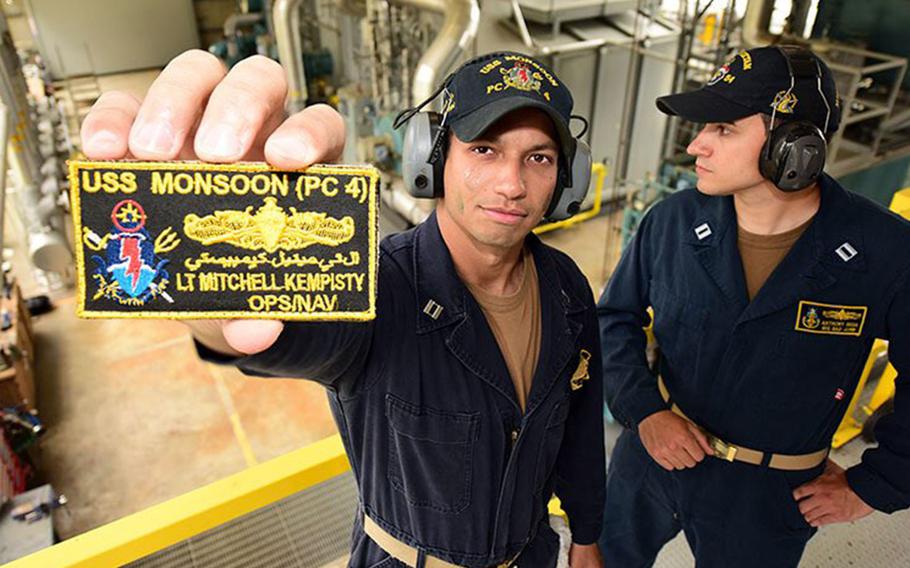 Navy Lt. Mitchell Kempisty shows off his invention, a name tage protector dubbed The Enforcer, in this undated photo taken aboard the patrol ship USS Monsoon. 