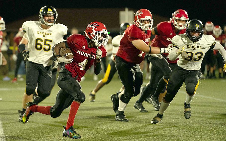 Nile C. Kinnick's Tre Bennnett looks to elude Kadena defender Flint Barton.