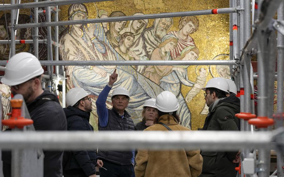 Technicians work at the restoration of the mosaics that adorn the dome of the Baptistery of San Giovanni, in Florence, central Italy, Feb. 7. 