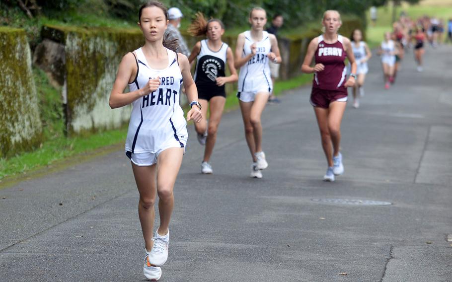 Girls overall winner Sofia Sato of Sacred Heart opens up space between her and teammate Payton Osborne, Zama's Liliana Fennessey and Matthew C. Perry's Jane Williams, the DODEA All-Japan winner.
