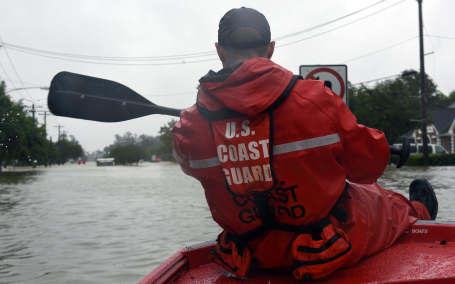 Coast Guard Chief Petty Officer Stephen Kelly helps launch a 16-foot flood punt boat to conduct urban rescues in Friendswood, Texas, Aug. 29, 2017, in the wake of Hurricane Harvey. 