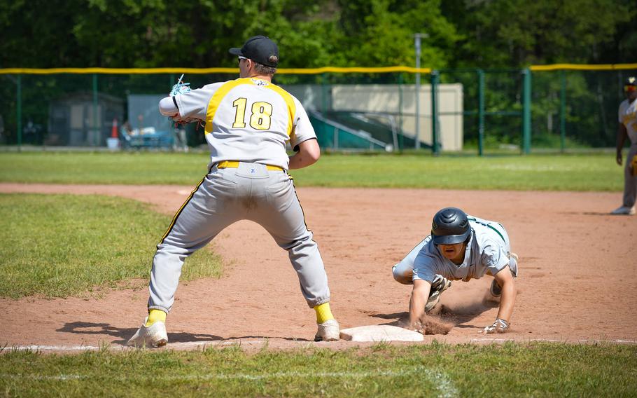 Naples’ Joshua Myrick dives back to second base before being tagged out by Vicenza’s shortstop Grady Lester, during the DODEA-Europe Division II-III Baseball Championships at Ramstein Air Base, Germany, May 18, 2023.