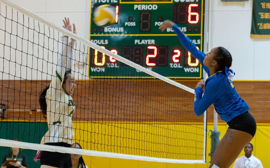 Yokota's Trinity Stegall spikes the ball against Robert D. Edgren's Milan Bean. The Panthers won in four sets.