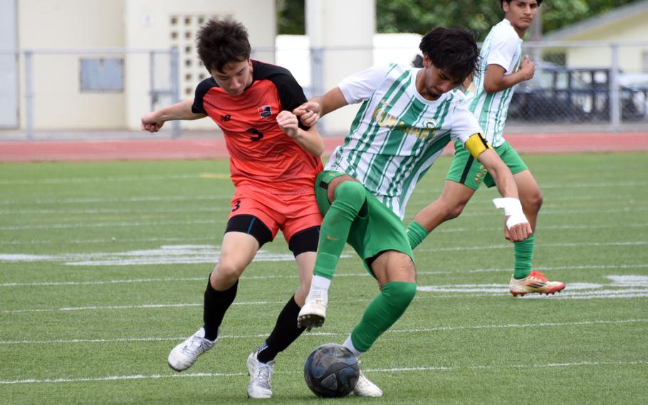 Kinnick's Haruto Takeda and Kubasaki's Izik Ramirez scuffle for the ball.