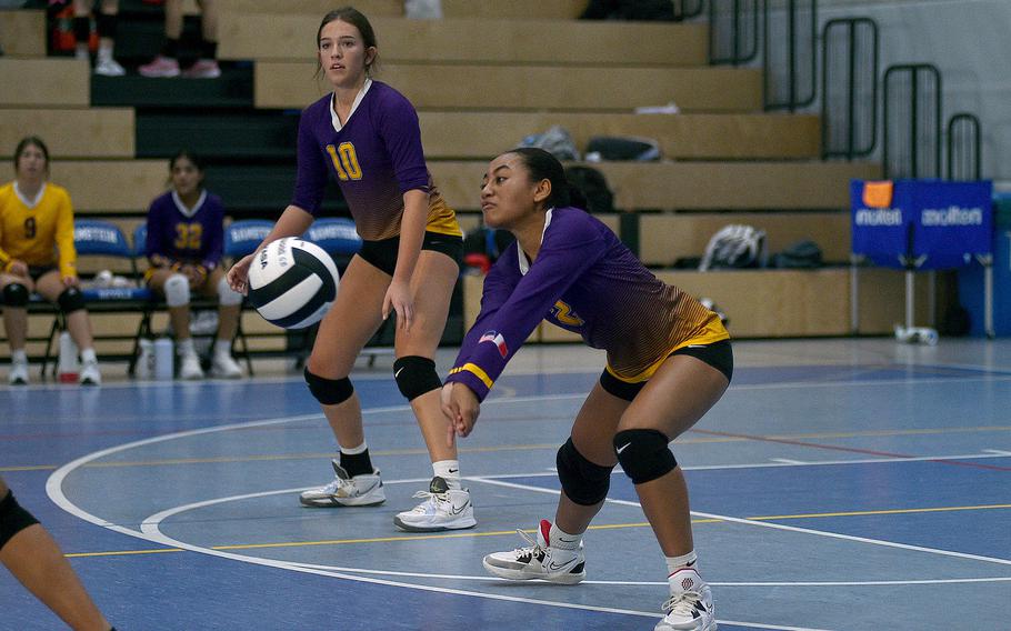 Bahrain's Jamilah Courts goes for a dig during the Falcons' match against Black Forest Academy during pool-play action of the DODEA European volleyball championships on Oct. 26, 2023, at Ramstein High School on Ramstein Air Base, Germany. in the background is teammate Elsie Williams.