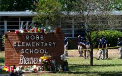 Investigators search for evidences outside Robb Elementary School in Uvalde, Texas, May 25, 2022, after an 18-year-old gunman killed 19 students and two teachers.