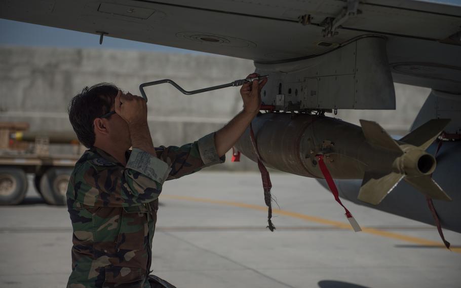 An Afghan airman adjusts the munitions mount underneath the wing of an A-29 Super Tucano Sept. 12, 2017, in Kabul, Afghanistan. A recently declassified government report stated that the Pentagon was aware well before the U.S. pullout from Afghanistan that the Afghan air force could collapse without foreign help.