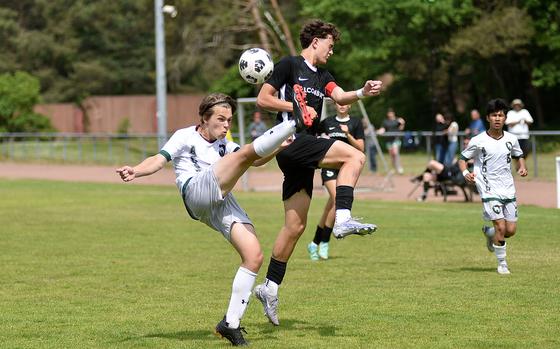 AFNORTH defender Sage Kallestad clears the ball ahead of Alconbury central attacking midfielder Leo Politis during a Division III semifinal match at the 2025 DODEA European championships on May 21, 2025, at Rothenborn Stadion in Landstuhl, Germany.