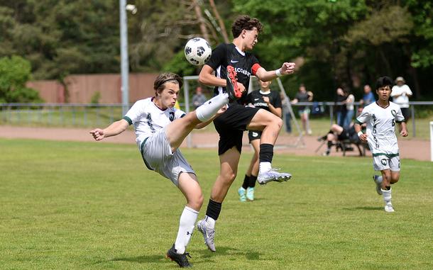 AFNORTH defender Sage Kallestad clears the ball ahead of Alconbury central attacking midfielder Leo Politis during a Division III semifinal match at the 2025 DODEA European championships on May 21, 2025, at Rothenborn Stadion in Landstuhl, Germany.