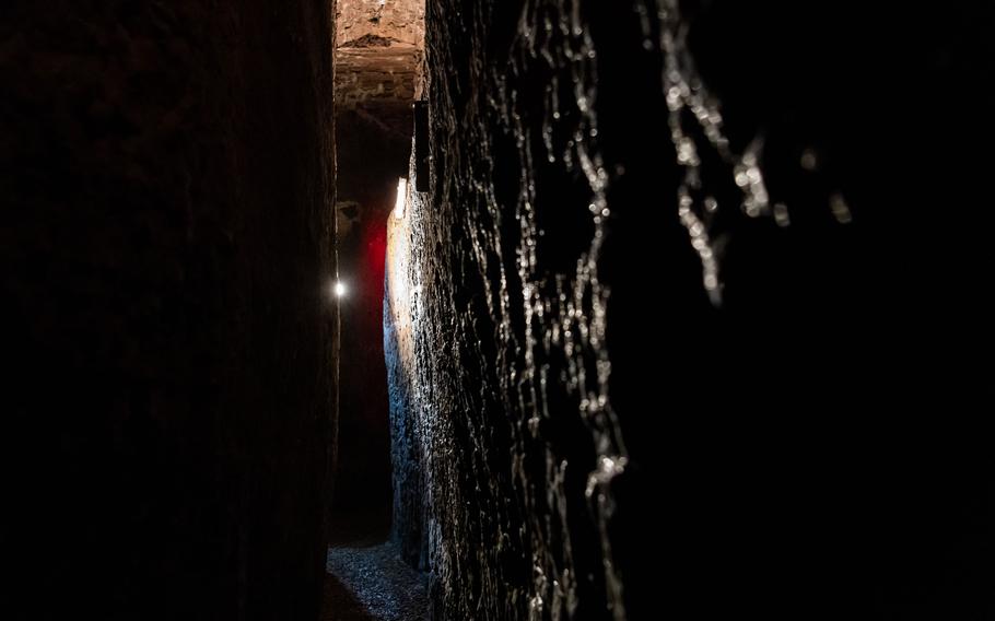 Traversing through a narrow and damp escape tunnel is one of the highlights of an underground tunnel tour in central Kaiserslautern organized by the city. 