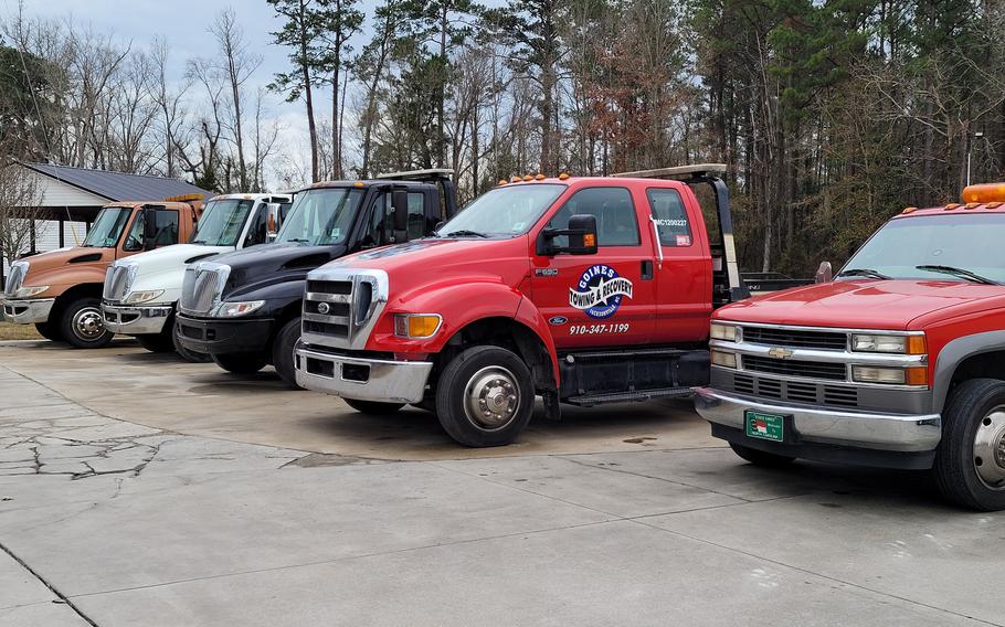 An undated image posted online by Goines Towing & Recovery shows tow trucks operated by the company, which is involved in a legal settlement with the Justice Department. The settlement addresses allegations of violating the Servicemembers Civil Relief Act by towing and selling vehicles belonging to service members without proper court disclosures. 