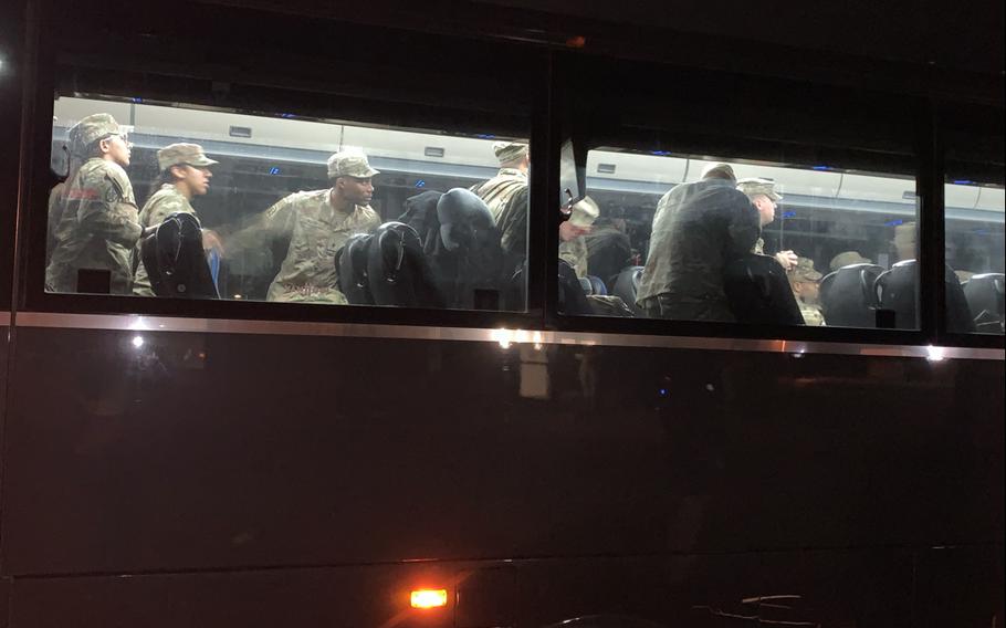 54th Quartermaster Company soldiers wait to exit a bus before being reunited with their families during a welcome home ceremony on April 12, 2024, at the Family Life Center on Fort Gregg-Adams, Va.