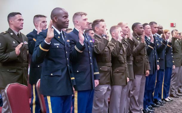 Graduates of the 129th Regiment (Regional Training Institute) Officer Candidate School, Camp Lincoln, Springfield, Illinois, recite the oath of office as newly-commissioned second lieutenants, at the commissioning ceremony Aug. 21 at Crowne Plaza hotel, Springfield, Illinois. Twenty-two Soldiers in the Illinois Army National Guard and one Soldier in the U.S. Army Reserves fulfilled the leadership and military education requirements to be commissioned as U.S. Army officers. Two graduates of the program decided to "hip-pocket" their commissions and seek federal recognition as officers at a later date.
