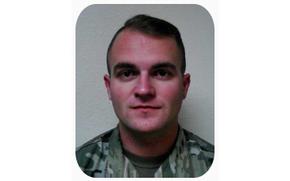 Photo of Spc. Taylor Adam Lee in uniform from the shoulders up.