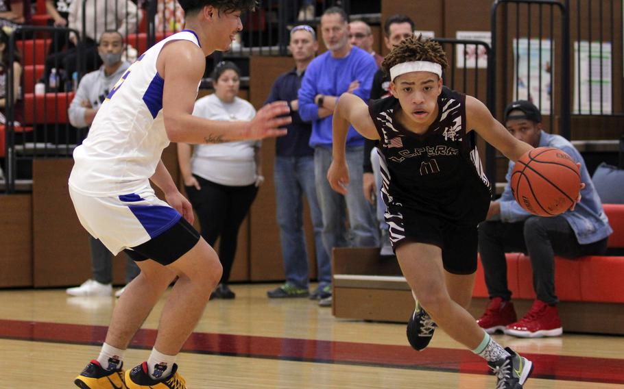 Matthew C. Perry's Jahiion Francois drives on Yokota's Dylan Tomas during Saturday's DODEA-Japan boys basketball game. The Panthers won 56-19.