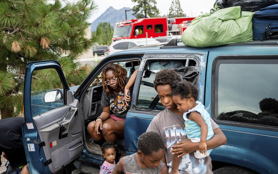Paisley Bamberg and her family spend time outside a shelter for McKinney Fire evacuees in Weed, Calif., on Monday, Aug. 1, 2022. Bamberg said they have stayed there for several days while waiting to return home to Yreka.