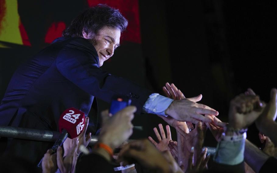 Presidential candidate of the Liberty Advances coalition Javier Milei greets supporters outside his campaign headquarters after winning the presidential runoff election in Buenos Aires, Argentina, Nov. 19, 2023. 