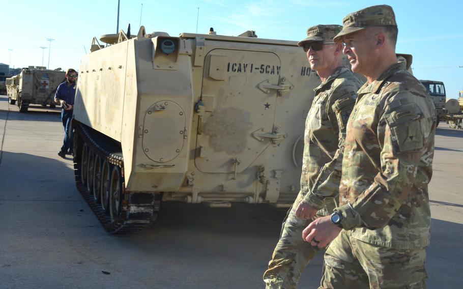 Lt. Gen. Sean Bernabe, commander of III Corps and Fort Cavazos, right, walks through a motor pool with Gen. Randy George, Army chief of staff, left, during a visit to the Texas post on Tuesday, Feb. 20, 2024. 