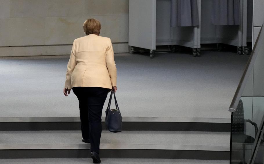 German Chancellor Angela Merkel leaves the plenary hall after a debate in Berlin on Tuesday, Sept. 7, 2021.