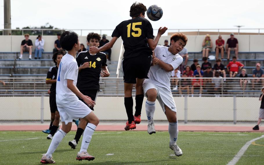 Kadena's Elias Cedeno heads the ball against CAJ's Hiro Maruyama.