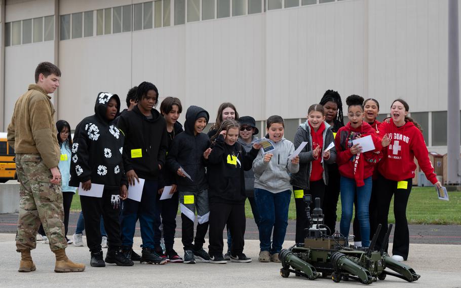 Students admire a robot dog during the Student Engagement and Career Day event at Joint Base McGuire-Dix-Lakehurst, N.J., Friday, April 19, 2024. 