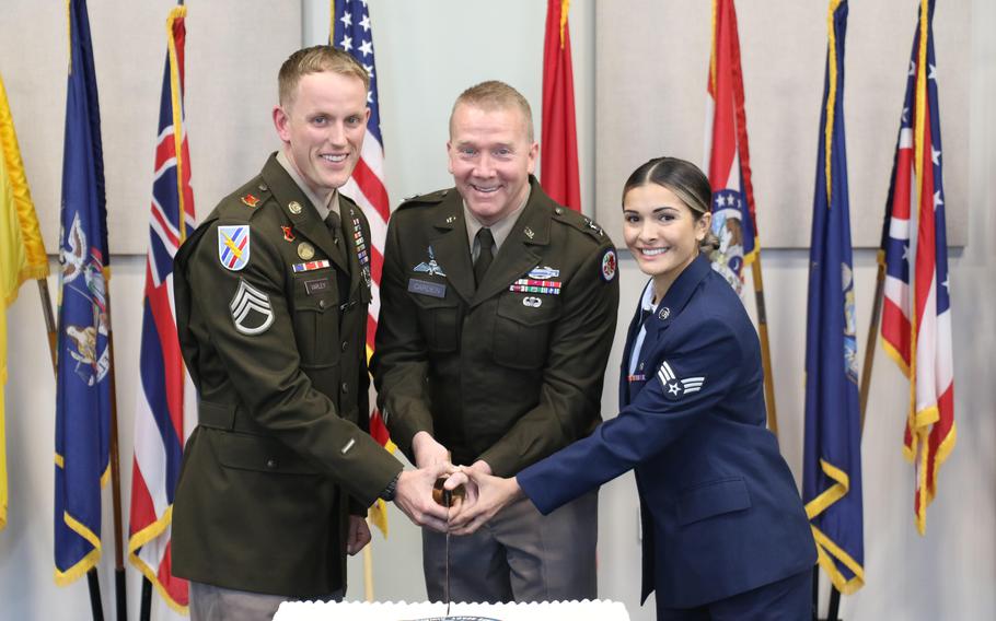 U.S. Army Maj. Gen. Thomas Carden, the adjutant general of the Georgia National Guard, cuts the cake along with the soldier and airman of the year, Staff Sgt. James Varley and Senior Airman Brittney Santos, during the 387th National Guard birthday ceremony Dec. 13, 2023, at the Clay National Guard Center in Marietta, Ga.