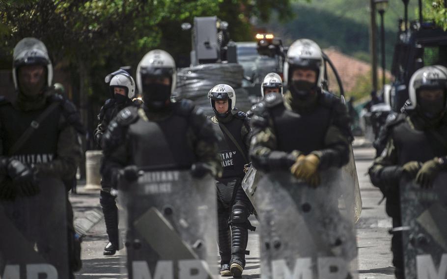 NATO soldiers and International military police secure the area near Zvecan, northern Kosovo, on May 30, 2023, a day following clashes with Serb protesters demanding the removal of recently elected Albanian mayors.