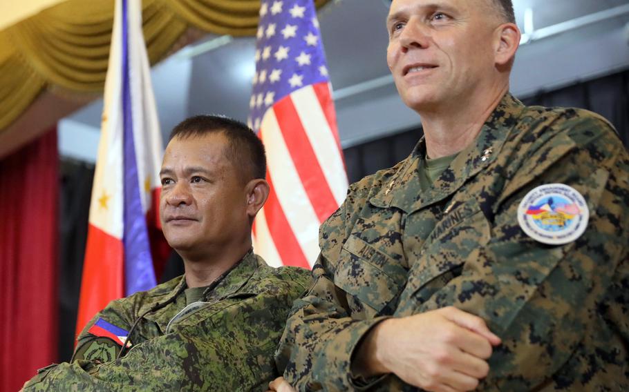 Maj.Gen. Eric Austin, commander of the 1st Marine Aircraft Wing, and Philippine army Maj Gen. Marvin Licudine attend the Balikatan exercise's opening ceremony at Camp Aguinaldo in Quezon city, northeast of Manila, Tuesday, April 11, 2023.