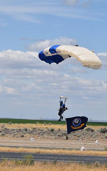 A man in a parachute landing.