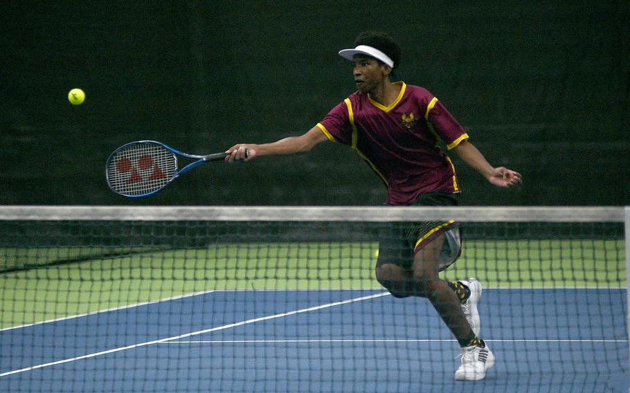 Vilseck's Cameron Holloway runs to the ball near the net during a match against Vicenza's Sam Grady in pool-play action of the DODEA European tennis championships on Oct. 19, 2023, at T2 Sports Health Club in Wiesbaden, Germany.