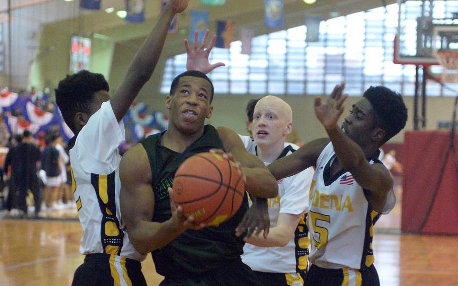 Kubasaki's T.J. Reese weaves through Kadena defensive traffic to the hoop during Sunday's third-place game, won by the Dragons 63-56.