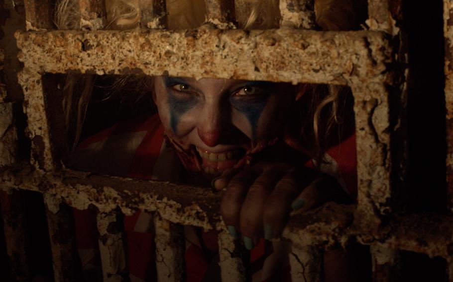 A scary clown peers out of a rusted cell door during the “Escape From Blood Prison” tour at The Ohio State Reformatory in Mansfield. 