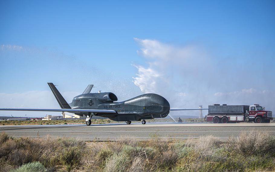 Fire trucks from the 812th Civil Engineer Squadron provide a water salute to an RQ-4 Global Hawk, assigned to and operated by the 452nd Flight Test Squadron, May 23, 2023, at Edwards Air Force Base in California. The 452nd FLTS marked the completion of the aircraft’s flight test program June 9, 2023.