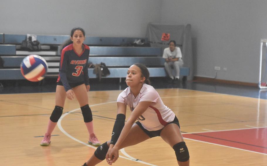 Aviano's Sophia Fisher squats low in order to return a ball from the other side of the net as the Saints split a pair of matches Saturday, Oct. 15, 2022, with the Ansbach Cougars.