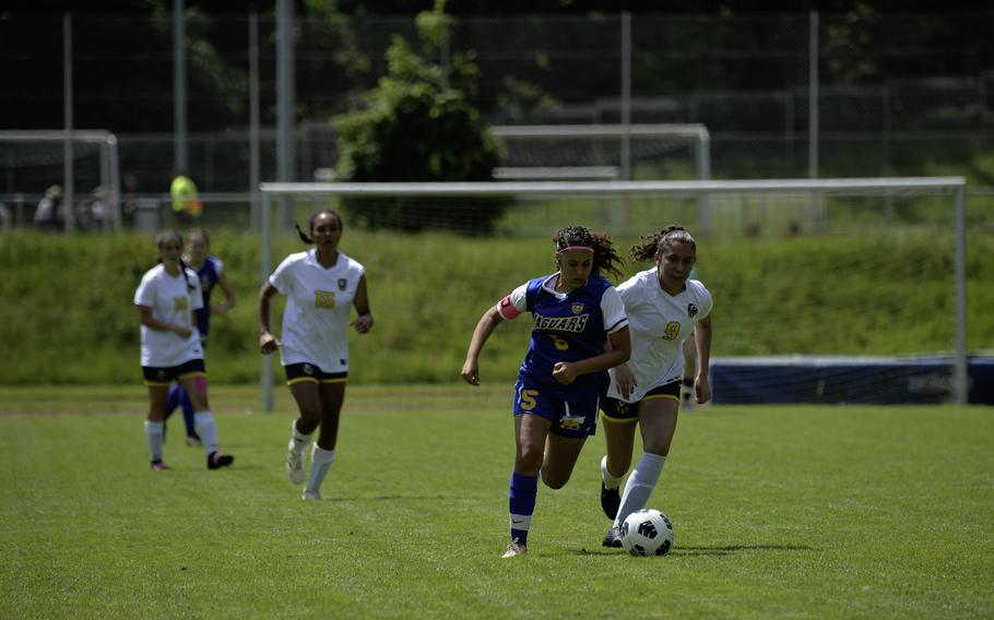 Charlize Caro of Sigonella runs past Ansbach’s Abigail Castillo during the 2024 DODEA European Soccer Division III Championships in Landstuhl, Germany, on May 20, 2024. Sigonella won the game 4-0.