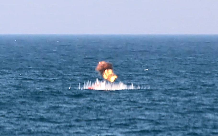 In this screenshot from video, munitions launched from a Lethal Miniature Aerial Missile System destroys a training target in the Persian Gulf during Exercise Digital Talon, Oct. 23, 2023. U.S. Naval Forces Central Command recently completed Exercise Digital Talon, demonstrating the ability of unmanned platforms to pair with traditionally crewed ships in manned-unmanned teaming to identify and target hostile forces at sea. Then, using munitions launched from another unmanned platform, engaged and destroyed those targets.