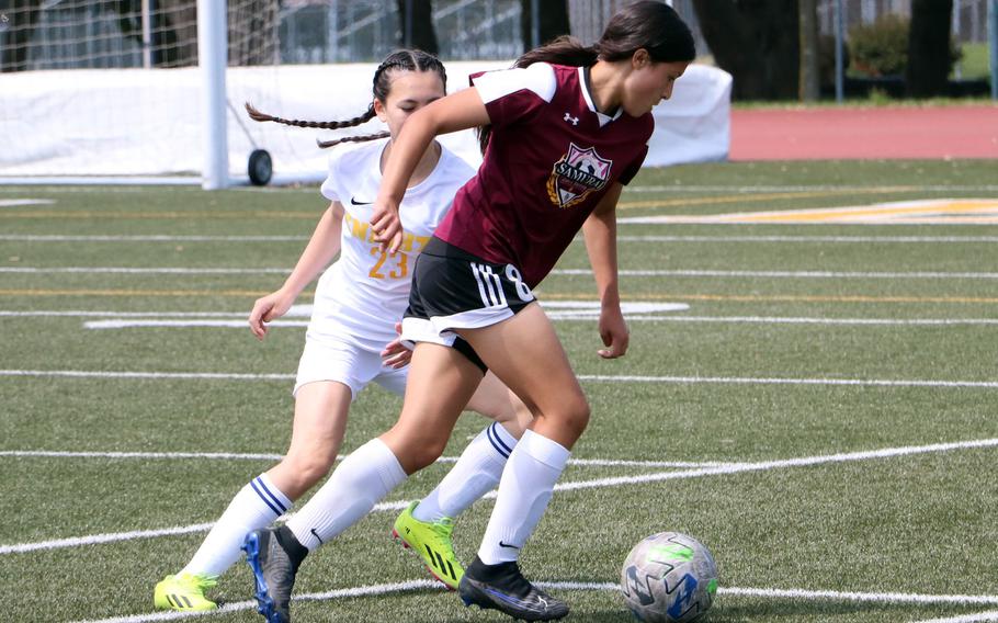 Matthew C. Perry’s Leilani Zuniga dribbled against Christian Academy Japan’s Erica Yokota during Monday’s girls Division II soccer tournament. The Samurai beat Zama 2-0, Daegu 3-0 and the Knights 1-0.