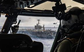 250525-N-FY193-1548 ATLANTIC OCEAN (May 25, 2025) An MH-60S Sea Hawk helicopter, attached to the "Dragonslayers" of Helicopter Sea Combat Squadron (HSC) 11, conducts a vertical-replenishment with the Nimitz-class aircraft carrier USS Harry S. Truman (CVN 75). Harry S. Truman, the flagship of the Harry S. Truman Carrier Strike Group (HSTCSG), is underway in the Atlantic Ocean on a regularly scheduled deployment. (U.S. Navy Photo by Mass Communication Specialist 3rd Class Mike Shen)