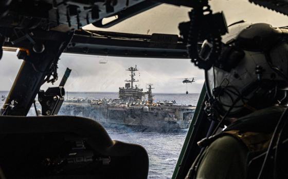250525-N-FY193-1548 ATLANTIC OCEAN (May 25, 2025) An MH-60S Sea Hawk helicopter, attached to the "Dragonslayers" of Helicopter Sea Combat Squadron (HSC) 11, conducts a vertical-replenishment with the Nimitz-class aircraft carrier USS Harry S. Truman (CVN 75). Harry S. Truman, the flagship of the Harry S. Truman Carrier Strike Group (HSTCSG), is underway in the Atlantic Ocean on a regularly scheduled deployment. (U.S. Navy Photo by Mass Communication Specialist 3rd Class Mike Shen)