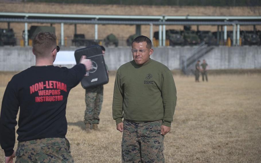 A Marine is sprayed with pepper spray during a training.