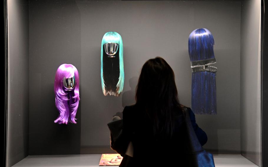 A visitor to “The Culture: Hip Hop and Contemporary Art in the 21st Century” at the Schirn in Frankfurt, Germany, looks at Dionne Alexander’s installation “Lil’ Kim Wigs, 1999-2001.”