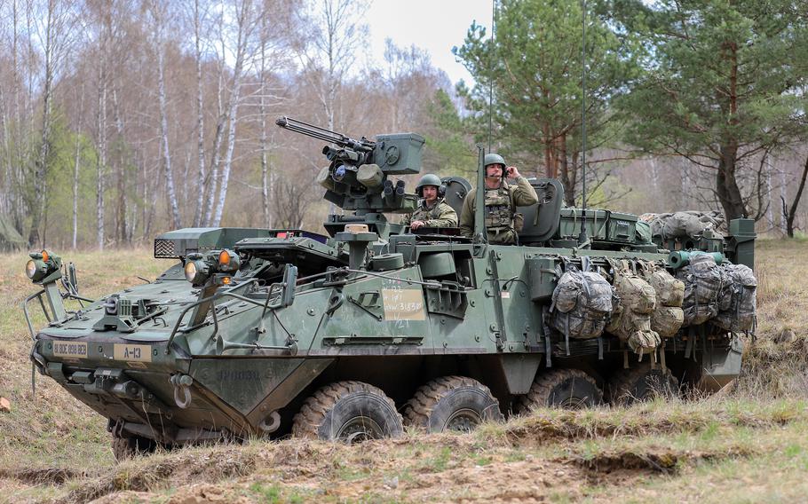 Cpl. Jason Cain, left, and Staff Sgt. Shawn Troxtel of the Washington Army National Guard man a reconnaissance Stryker during training near Orzysz, Poland, on April 27, 2022. The training ground there is home to one of NATO’s multinational battlegroups and is near the border with Kaliningrad, a Russian exclave.