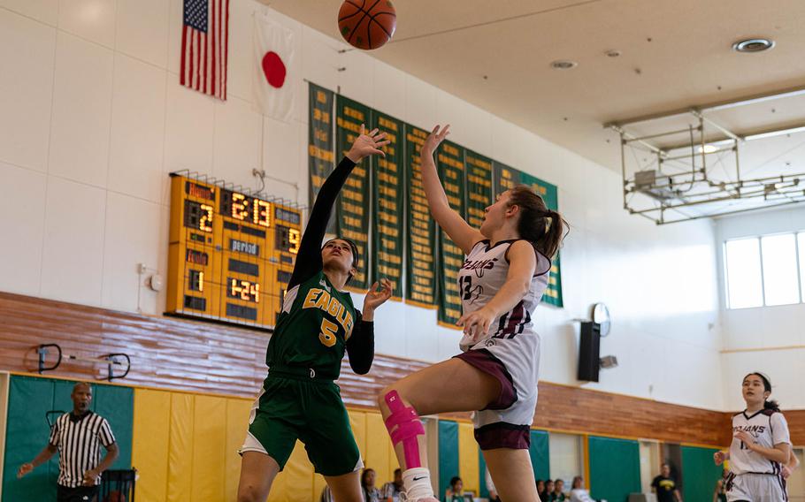 Robert D. Edgren's I'Lei Washington and Zama's Juliet Bitor leap toward a loose ball.