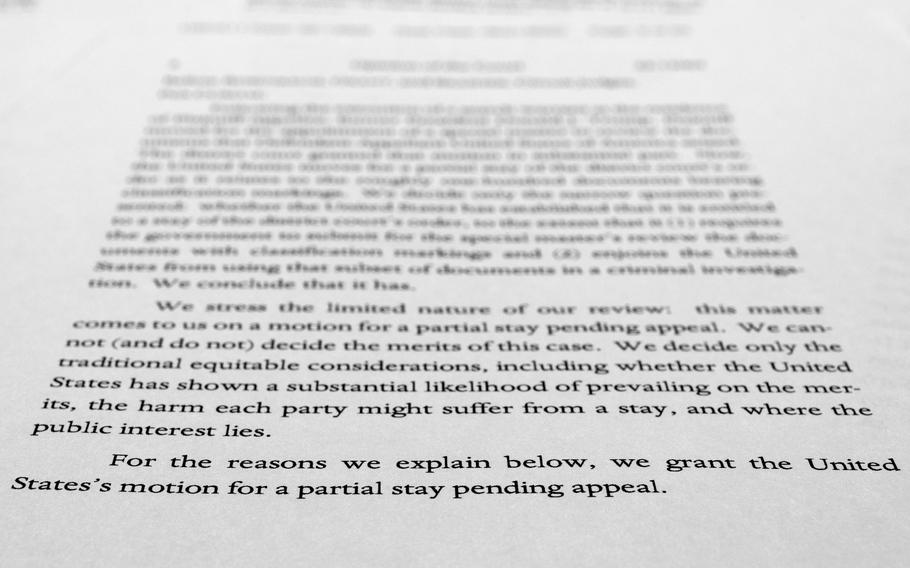 A page from a U.S. Court of Appeals for the 11th Circuit in Atlanta ruling that lifts a judge's hold on the Justice Department's ability to use classified documents seized by the FBI at Trump's Mar-a-Lago estate, is photographed Wednesday, Sept. 21, 2022. The ruling clears the way for the department to immediately resume its use of the documents in its investigation.