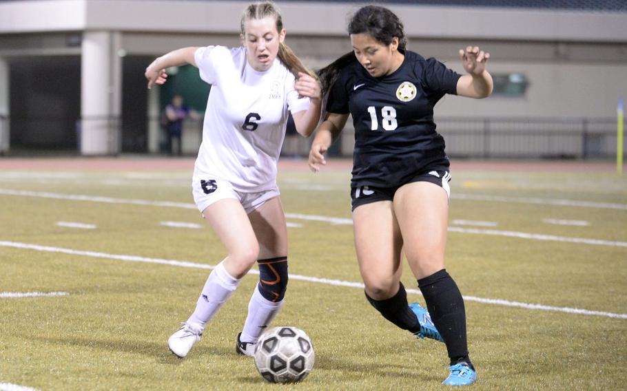 Zama’s Lainey Felt and Matthew C. Perry’s Markeean Lutz battle for the ball during Friday’s DODEA-Japan girls soccer match. The Samurai won 4-0.