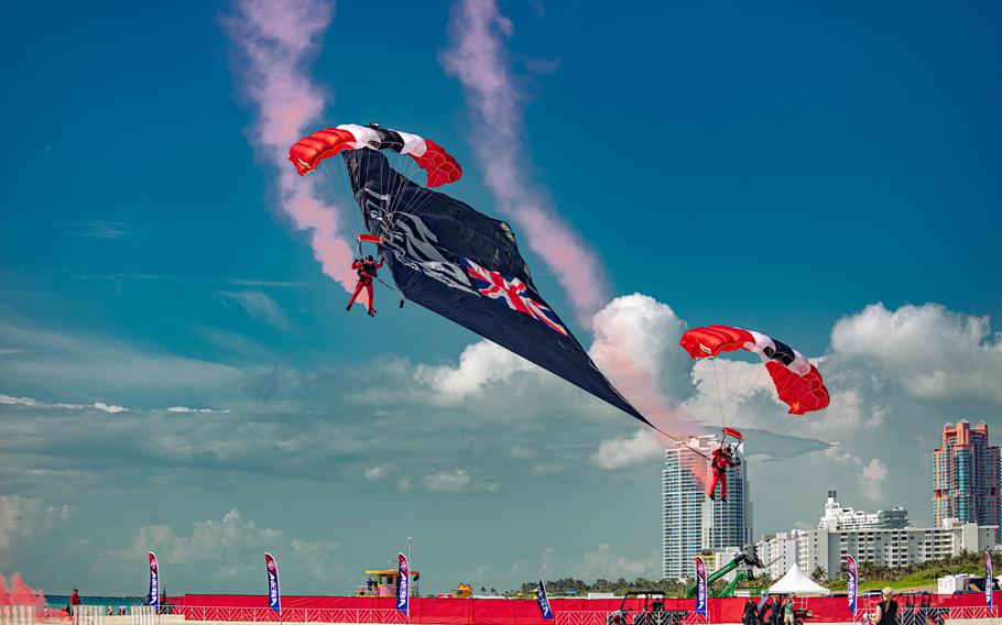 Members of the British Army Red Devils fly a drop flag onto Miami Beach
